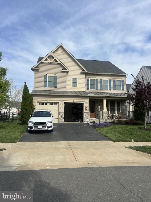 7901 Lukes Lodge Pl, Gainesville, VA 20155 - view of front of property featuring a standing seam roof, a garage, driveway, a metal roof, and a porch