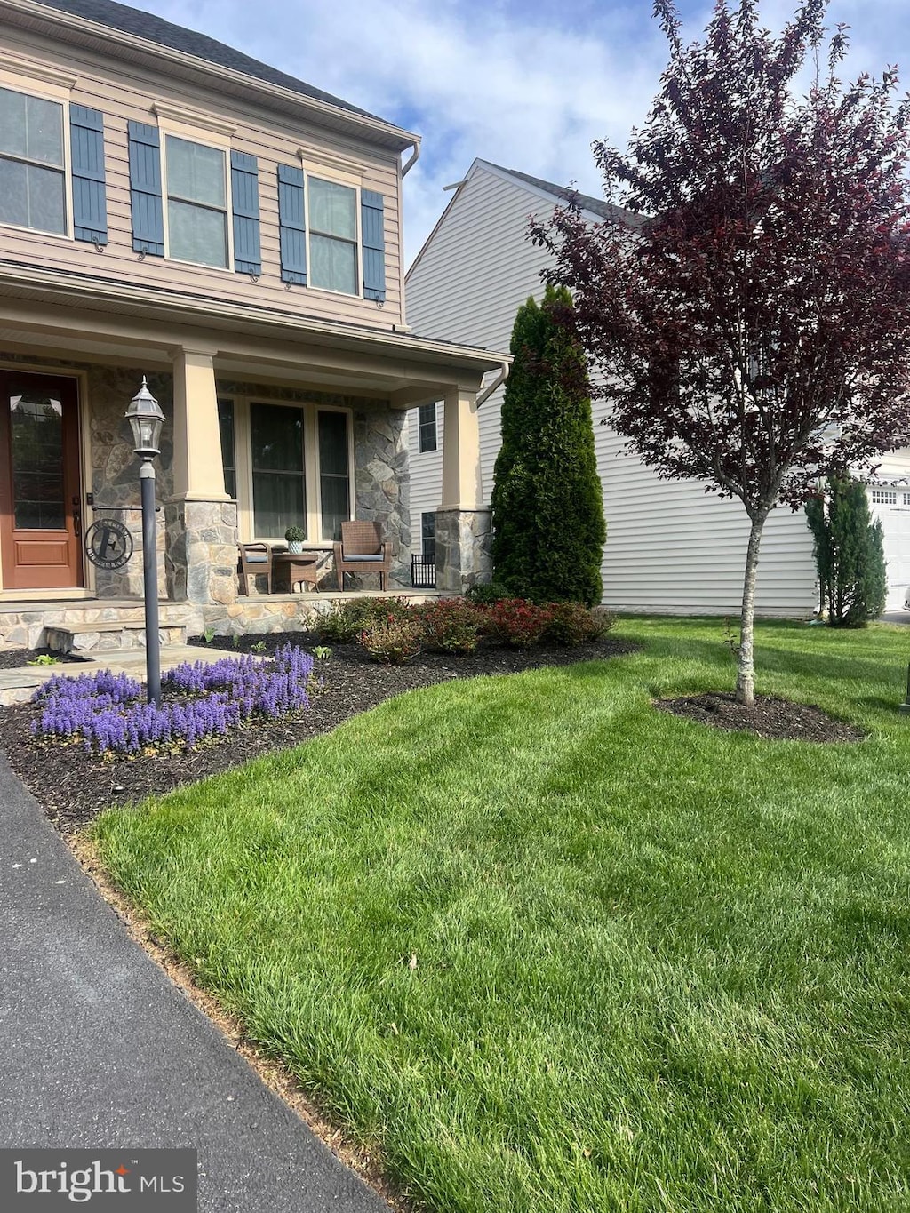 7901 Lukes Lodge Pl, Gainesville, VA 20155 - view of front of property with stone siding, covered porch, and a front lawn