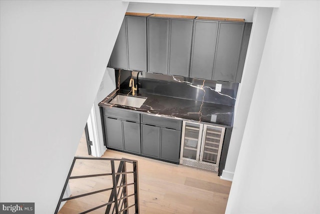2618 E Hagert St, Philadelphia, PA 19125 - kitchen featuring gray cabinetry, beverage cooler, dark countertops, and light wood-style flooring