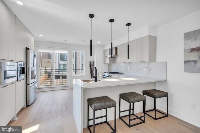 2618 E Hagert St, Philadelphia, PA 19125 - kitchen featuring appliances with stainless steel finishes, light wood-style flooring, modern cabinets, a breakfast bar, and recessed lighting