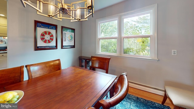 1047 Brookfield Cir, Quakertown, PA 18951 - dining area with a baseboard heating unit, a chandelier, and wood finished floors