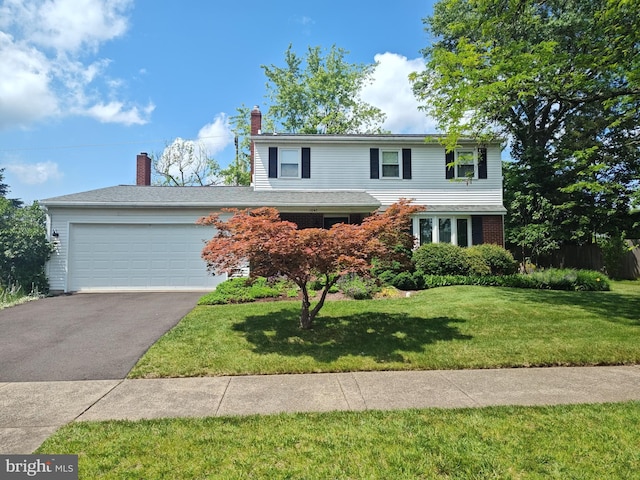 1047 Brookfield Cir, Quakertown, PA 18951 - traditional home featuring driveway, an attached garage, a front yard, and a chimney
