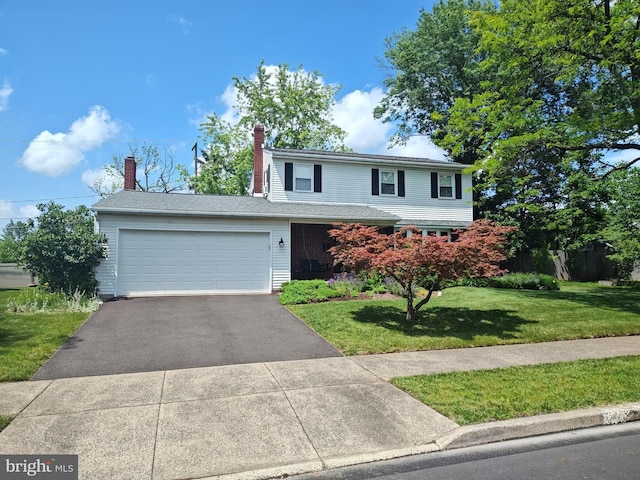 1047 Brookfield Cir, Quakertown, PA 18951 - traditional-style house with asphalt driveway, a front yard, an attached garage, and a chimney