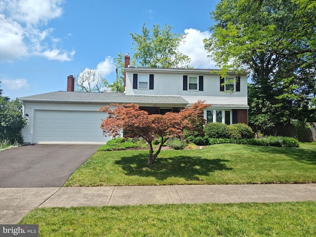 1047 Brookfield Cir, Quakertown, PA 18951 - traditional home with asphalt driveway, an attached garage, a front lawn, and a chimney