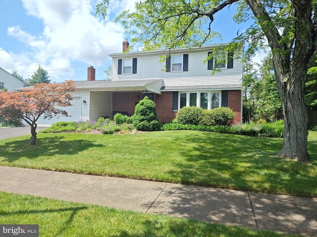 1047 Brookfield Cir, Quakertown, PA 18951 - traditional-style home with a garage, brick siding, a chimney, a front yard, and driveway