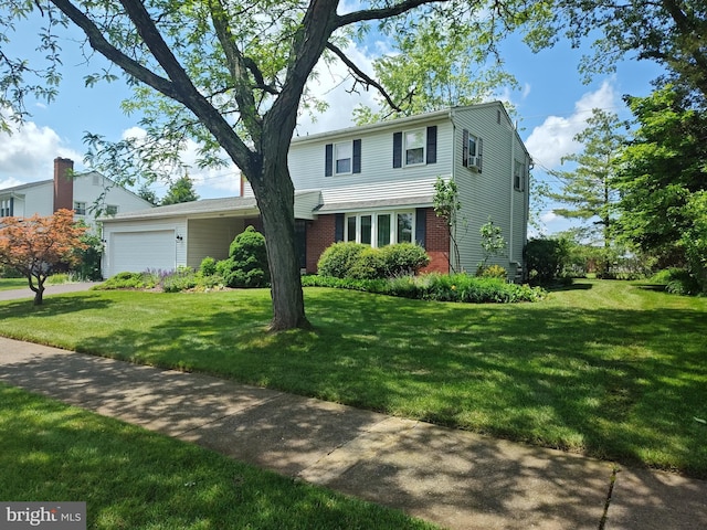 1047 Brookfield Cir, Quakertown, PA 18951 - traditional home with an attached garage, a front lawn, and brick siding