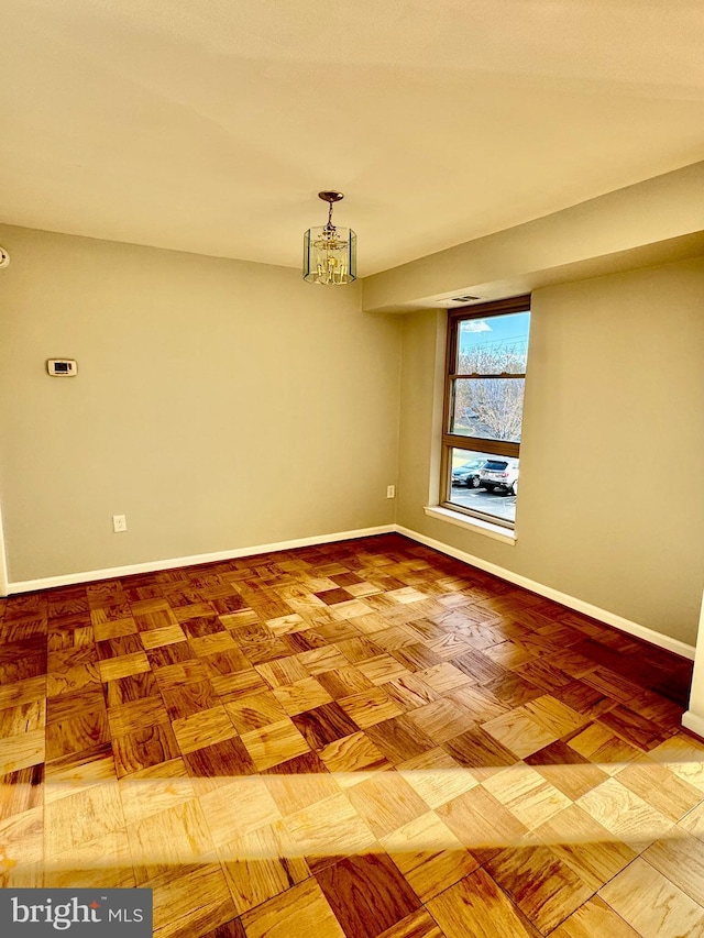 2205 Greenery Ln Unit 104-9, Silver Spring, MD 20906 - unfurnished room featuring baseboards and a chandelier