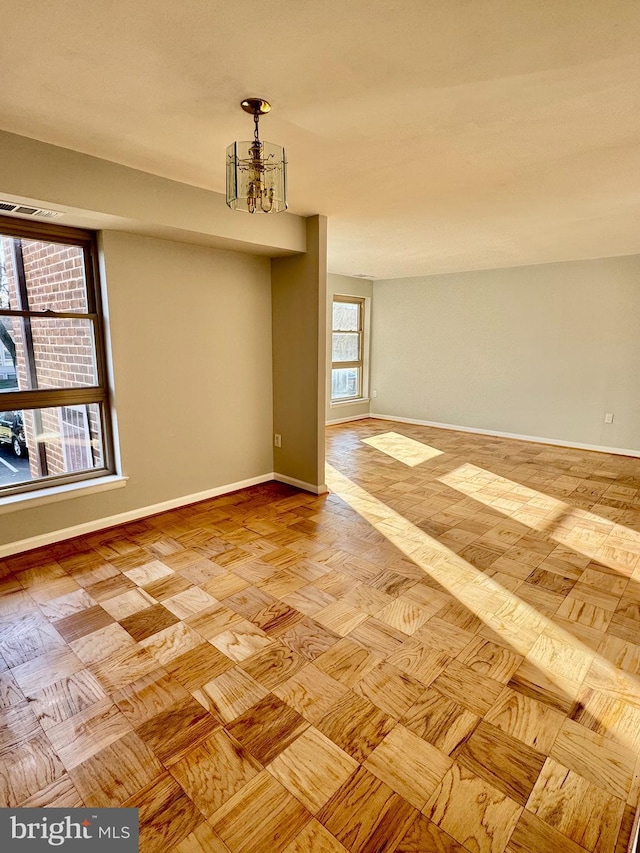 2205 Greenery Ln Unit 104-9, Silver Spring, MD 20906 - unfurnished room featuring baseboards and a chandelier