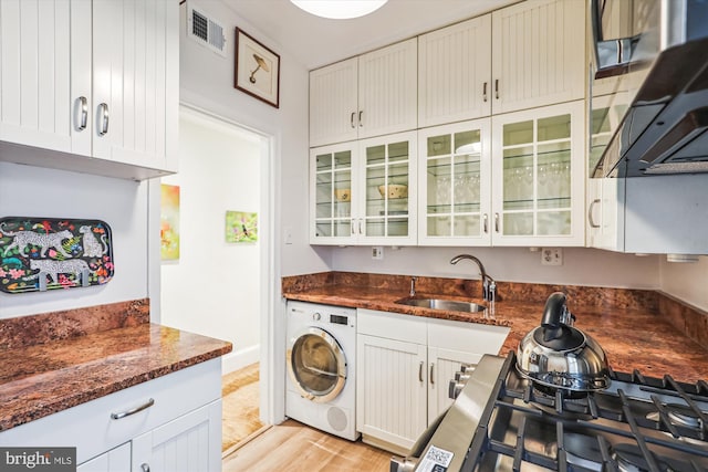 3042 R St NW Unit 2, Washington, DC 20007 - kitchen with washer / clothes dryer, ventilation hood, and white cabinets