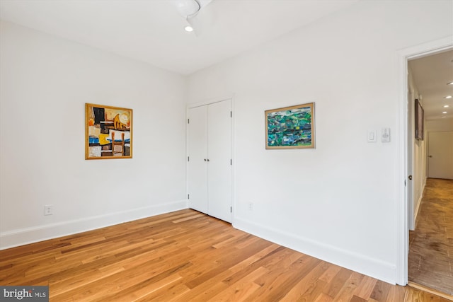 3042 R St NW Unit 2, Washington, DC 20007 - spare room featuring baseboards and light wood-style floors