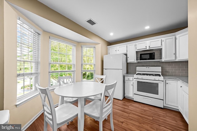 564 Astor Sq, West Chester, PA 19380 - kitchen with white appliances, light countertops, white cabinetry, dark wood finished floors, and decorative backsplash