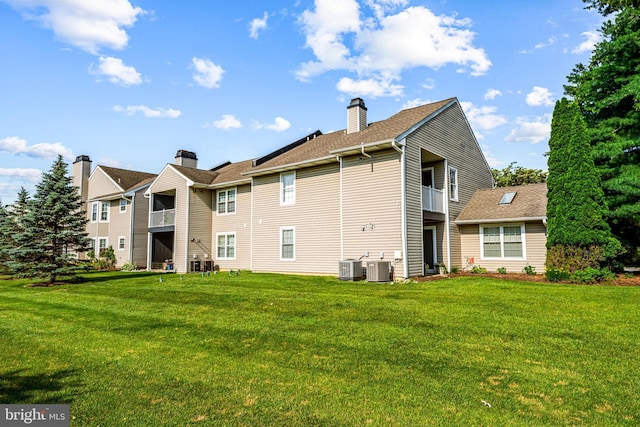564 Astor Sq, West Chester, PA 19380 - back of house with a yard, a chimney, and roof with shingles