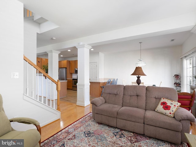 111 Sandridge Ct Unit 6-Jul, Millsboro, DE 19966 - living room with light wood-style floors, ornate columns, recessed lighting, and stairway