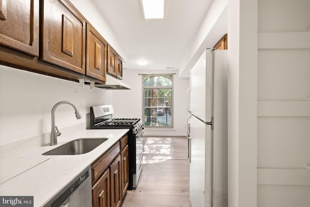 3378 Woodburn Rd Unit 11, Annandale, VA 22003 - kitchen with stainless steel appliances, light wood finished floors, light countertops, and under cabinet range hood