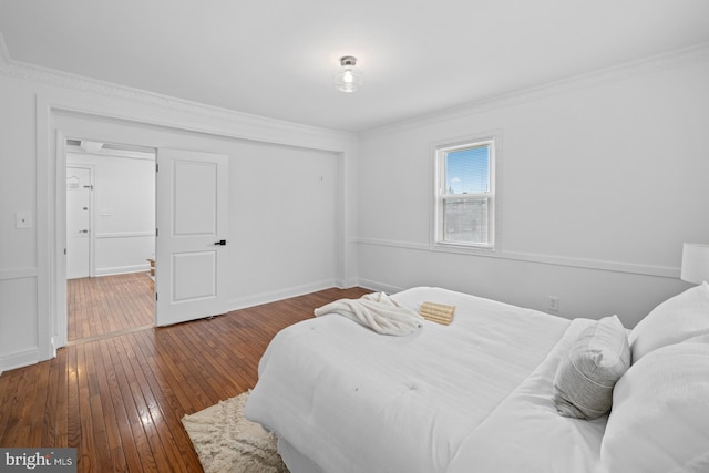950 E W Hwy, Takoma Park, MD 20912 - bedroom with wood-type flooring, crown molding, and a closet