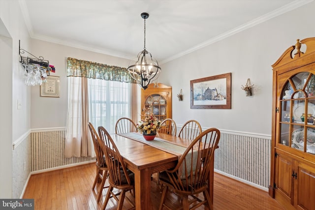 302 Cressent Ct, East Fallowfield Township, PA 19320 - dining area featuring light wood-style flooring, a chandelier, a wainscoted wall, and ornamental molding