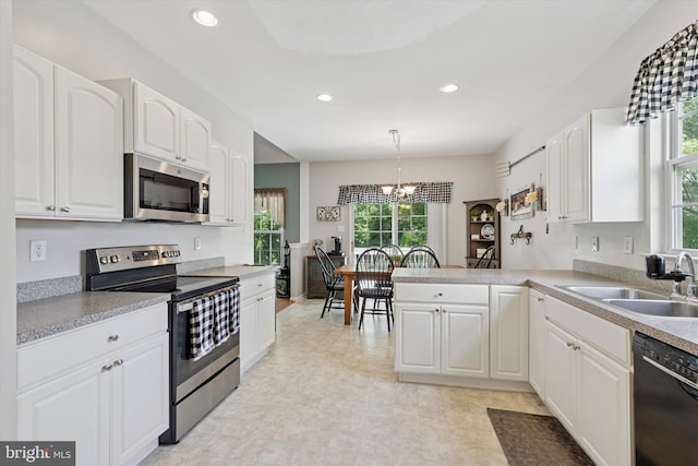 302 Cressent Ct, East Fallowfield Township, PA 19320 - kitchen with appliances with stainless steel finishes, plenty of natural light, white cabinetry, a peninsula, and recessed lighting