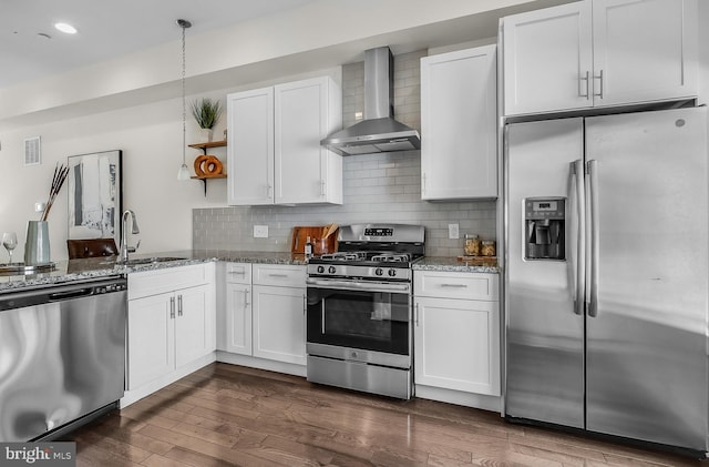 1620 N 5th Ct, Philadelphia, PA 19122 - kitchen featuring stainless steel appliances, wall chimney range hood, stone counters, white cabinets, and tasteful backsplash