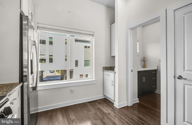 1620 N 5th Ct, Philadelphia, PA 19122 - kitchen featuring dark wood-type flooring, plenty of natural light, appliances with stainless steel finishes, and white cabinetry