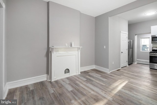 2332 N 25th St, Philadelphia, PA 19132 - unfurnished living room with wood finished floors and baseboards