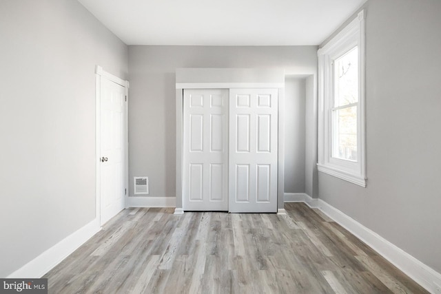 2332 N 25th St, Philadelphia, PA 19132 - unfurnished bedroom with light wood-type flooring and a closet