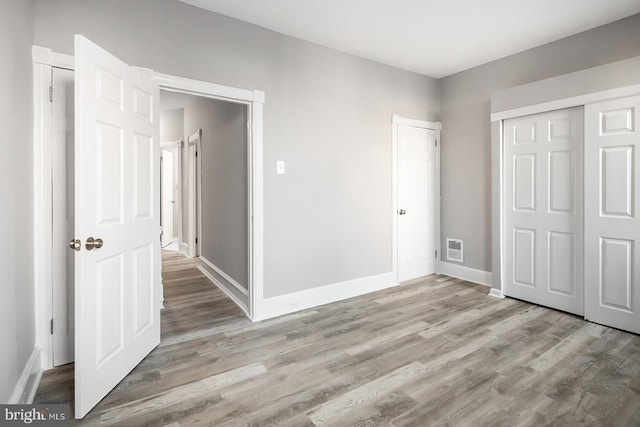2332 N 25th St, Philadelphia, PA 19132 - unfurnished bedroom with light wood-style floors and a closet
