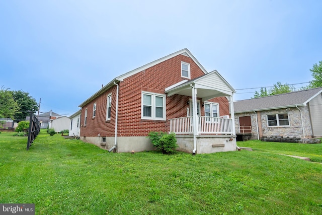 519 Jefferson St, East Greenville, PA 18041 - view of front of house with brick siding, a porch, and a front yard