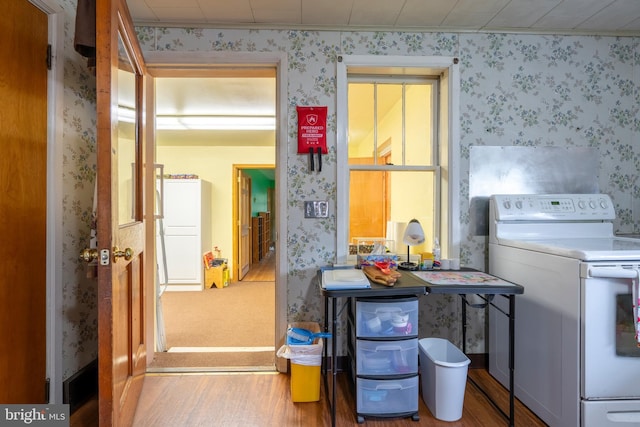 519 Jefferson St, East Greenville, PA 18041 - kitchen with white electric range, wood finished floors, and wallpapered walls
