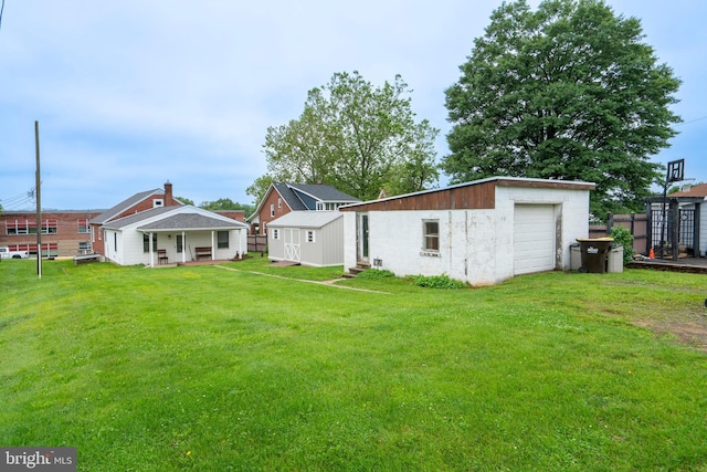 519 Jefferson St, East Greenville, PA 18041 - back of property featuring an outdoor structure, a lawn, and a detached garage