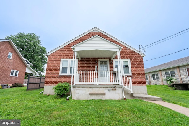 519 Jefferson St, East Greenville, PA 18041 - bungalow-style home with brick siding, a front yard, and covered porch