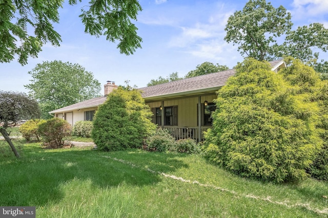 724 Franklinville Rd, Mullica Hill, NJ 08062 - rear view of house with a chimney, a porch, roof with shingles, and a yard