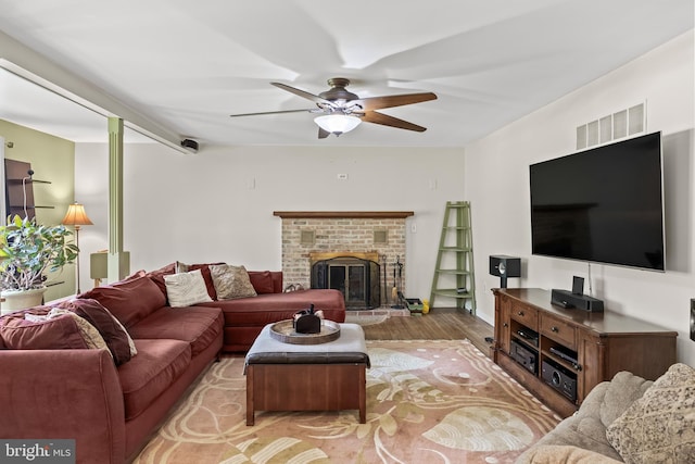 724 Franklinville Rd, Mullica Hill, NJ 08062 - living area with wood finished floors, a ceiling fan, and a brick fireplace