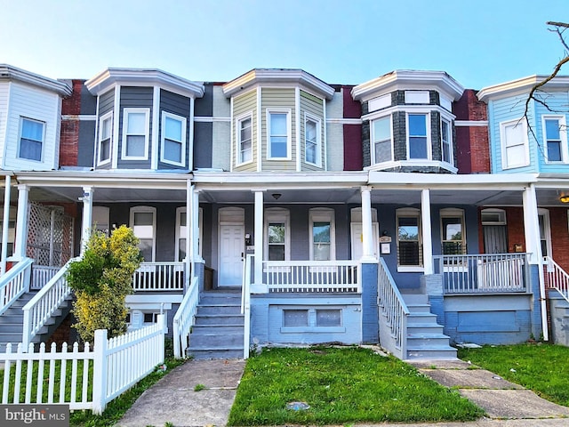 3613 W Belvedere Ave, Baltimore, MD 21215 - townhome / multi-family property featuring stairway and a porch