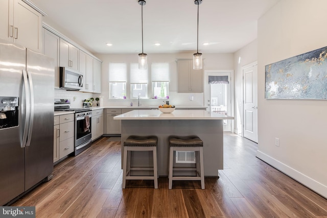 17153 Cumberland Height Dr, Dumfries, VA 22026 - kitchen with appliances with stainless steel finishes, tasteful backsplash, dark wood-style floors, light countertops, and recessed lighting
