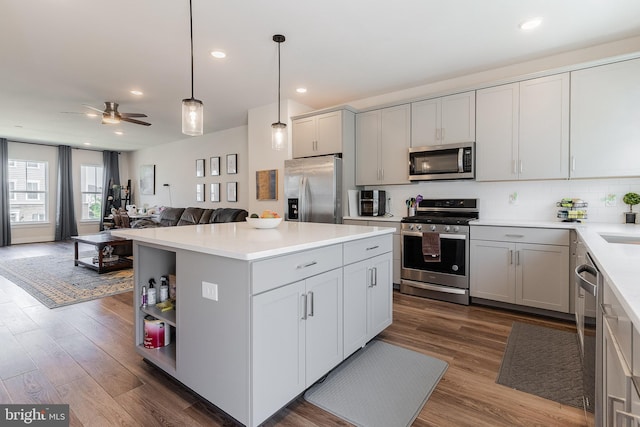 17153 Cumberland Height Dr, Dumfries, VA 22026 - kitchen featuring appliances with stainless steel finishes, gray cabinets, open floor plan, ceiling fan, and a center island