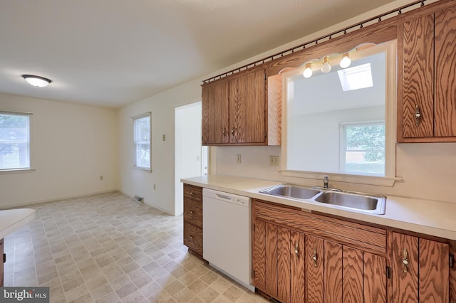 15 Jason Ave, Denver, PA 17517 - kitchen featuring dishwasher, brown cabinets, light countertops, light floors, and a skylight