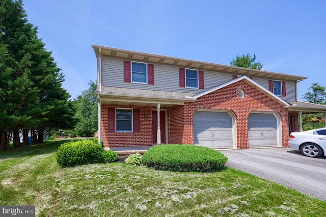 15 Jason Ave, Denver, PA 17517 - view of front of house with asphalt driveway, brick siding, an attached garage, a front lawn, and a porch