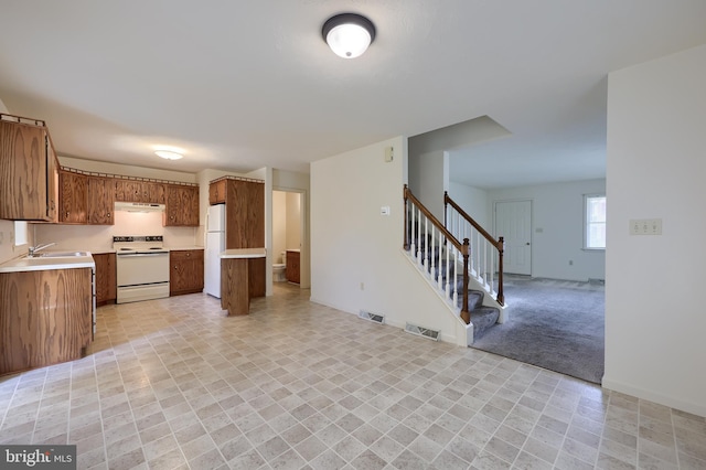 15 Jason Ave, Denver, PA 17517 - kitchen featuring white appliances, open floor plan, light countertops, and brown cabinets