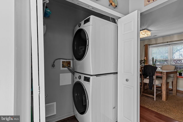907 Potters Pl, Southampton, PA 18966 - laundry room featuring stacked washer / drying machine and wood finished floors