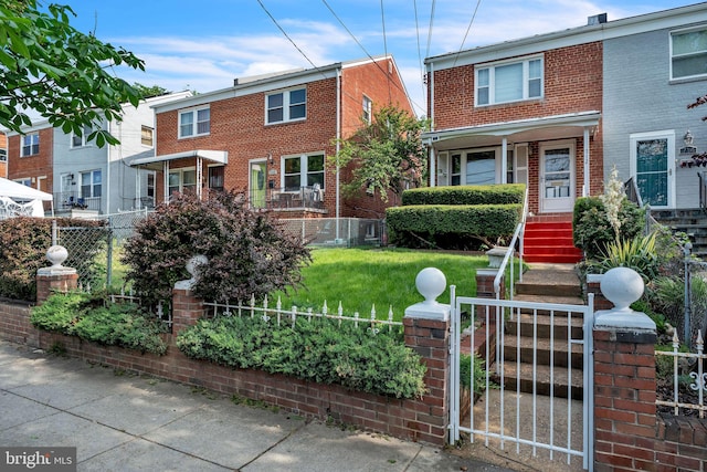 712 Chesapeake St SE, Washington, DC 20032 - view of front of home featuring a fenced front yard, brick siding, and a gate