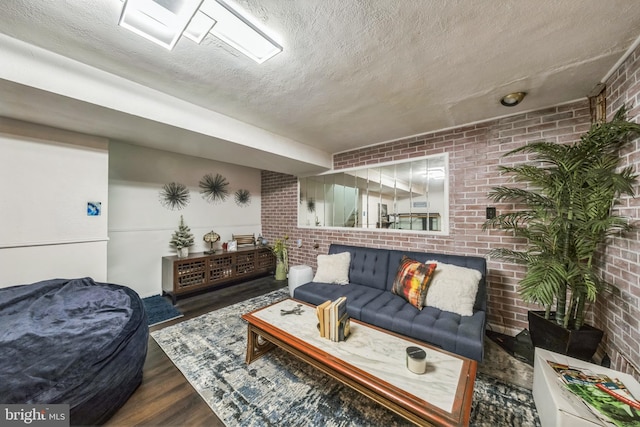 712 Chesapeake St SE, Washington, DC 20032 - living room with brick wall, a textured ceiling, and wood finished floors