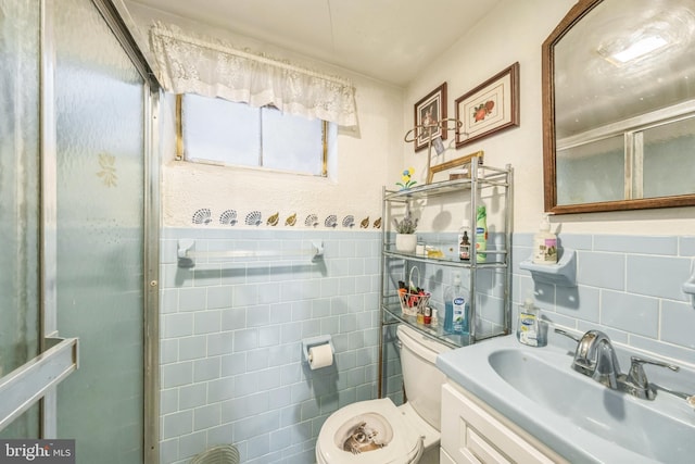 712 Chesapeake St SE, Washington, DC 20032 - bathroom featuring tile walls, vanity, a stall shower, and wainscoting