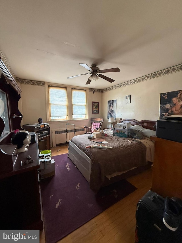 7221 Charles St, Philadelphia, PA 19135 - bedroom featuring radiator heating unit, wood finished floors, and ceiling fan