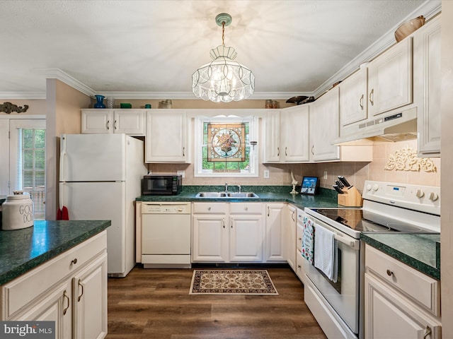 1360 N Childs Rd, Kearneysville, WV 25430 - kitchen featuring white appliances, under cabinet range hood, dark countertops, crown molding, and dark wood finished floors