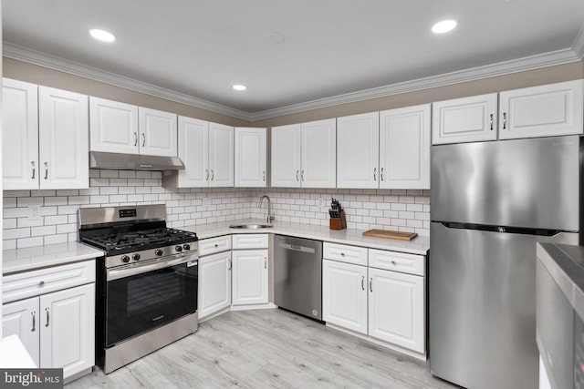 708 Zlotkin Cir, Freehold, NJ 07728 - kitchen with stainless steel appliances, under cabinet range hood, crown molding, light countertops, and white cabinetry