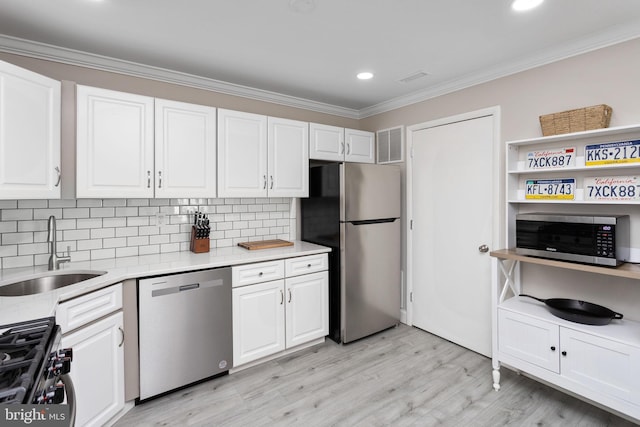 708 Zlotkin Cir, Freehold, NJ 07728 - kitchen with appliances with stainless steel finishes, crown molding, white cabinetry, light countertops, and backsplash