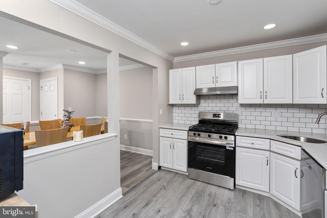 708 Zlotkin Cir, Freehold, NJ 07728 - kitchen with stainless steel appliances, under cabinet range hood, light wood-style floors, white cabinets, and light countertops