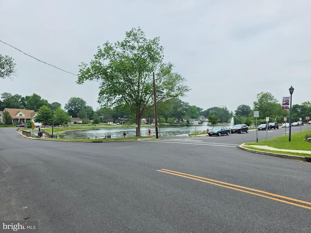 53 Valley Rd, Mount Ephraim, NJ 08059 - view of asphalt street with curbs, a water view, street lighting, sidewalks, and traffic signs