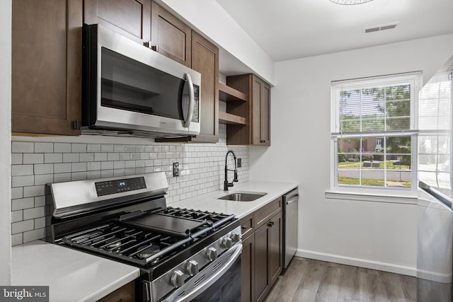 2193 Harbour Dr, Palmyra, NJ 08065 - kitchen with appliances with stainless steel finishes, wood finished floors, decorative backsplash, light countertops, and open shelves