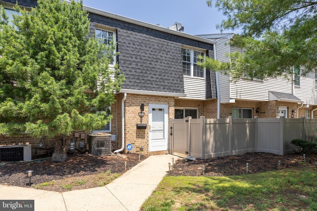 2193 Harbour Dr, Palmyra, NJ 08065 - view of property featuring brick siding, roof with shingles, and mansard roof